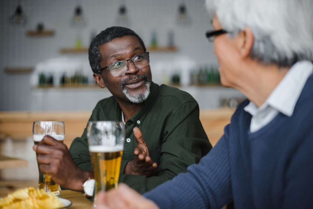 man with friend having a beer and a chat