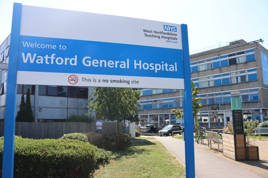 A sign outside a building which says Watford General Hospital on it