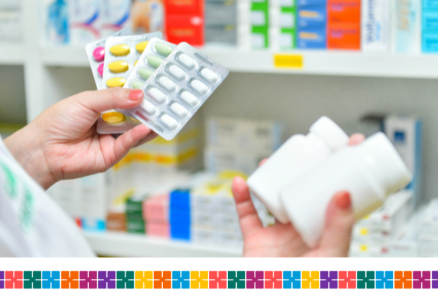 A person holding some blister packs and plastic containers showing different types of medication