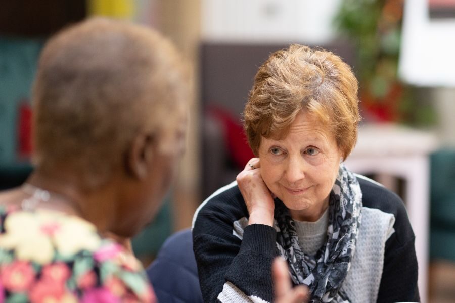 Older lady listening intently to conversation