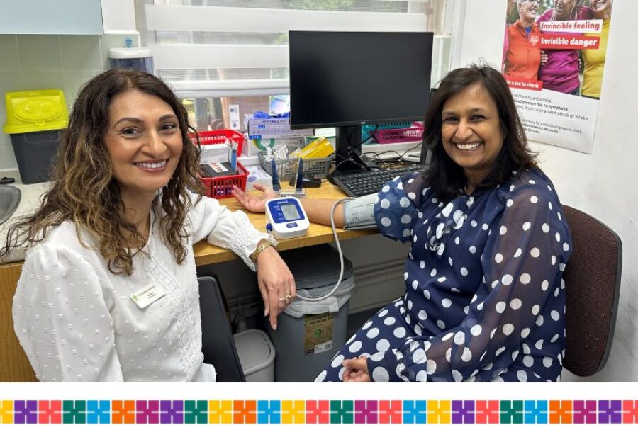 Woman having blood pressure checked in a pharmacy consultation room