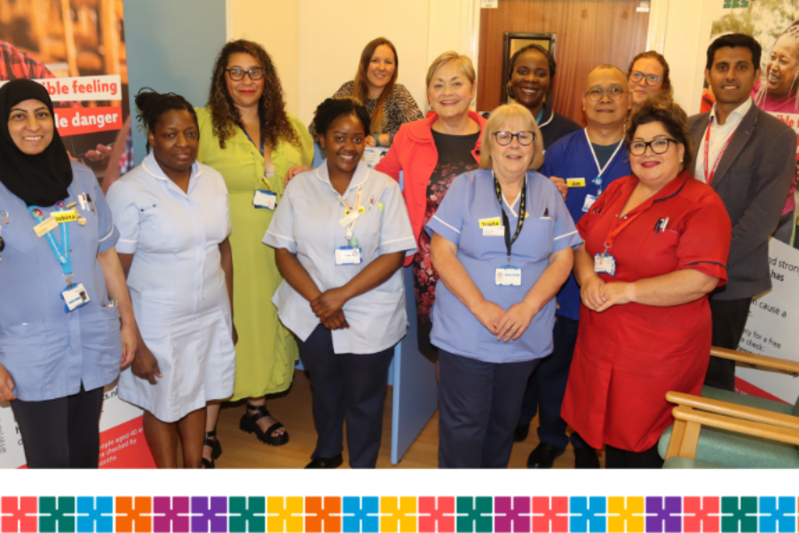 Members of West Herts Teaching Hospitals Trust's outpatients department stand together for a photo. Behind them are banners for the blood pressure campaign in Hertfordshire and west Essex.