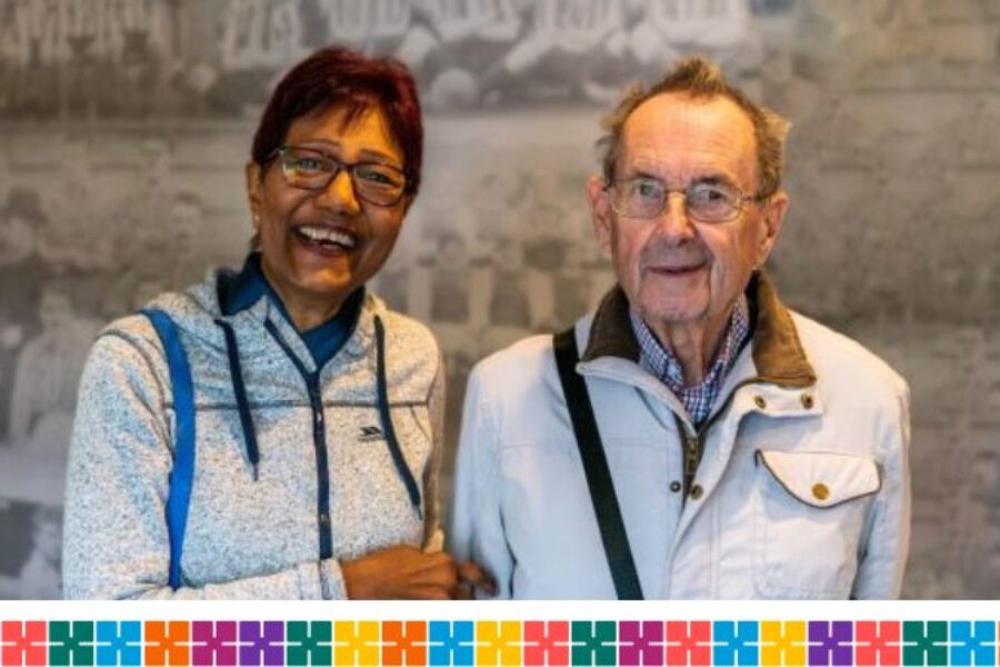 A man and woman smiling after having their vaccinations